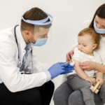 A pediatrician administering a vaccine to a baby, highlighting the importance of staying up-to-date with the 2024 baby immunization schedule.