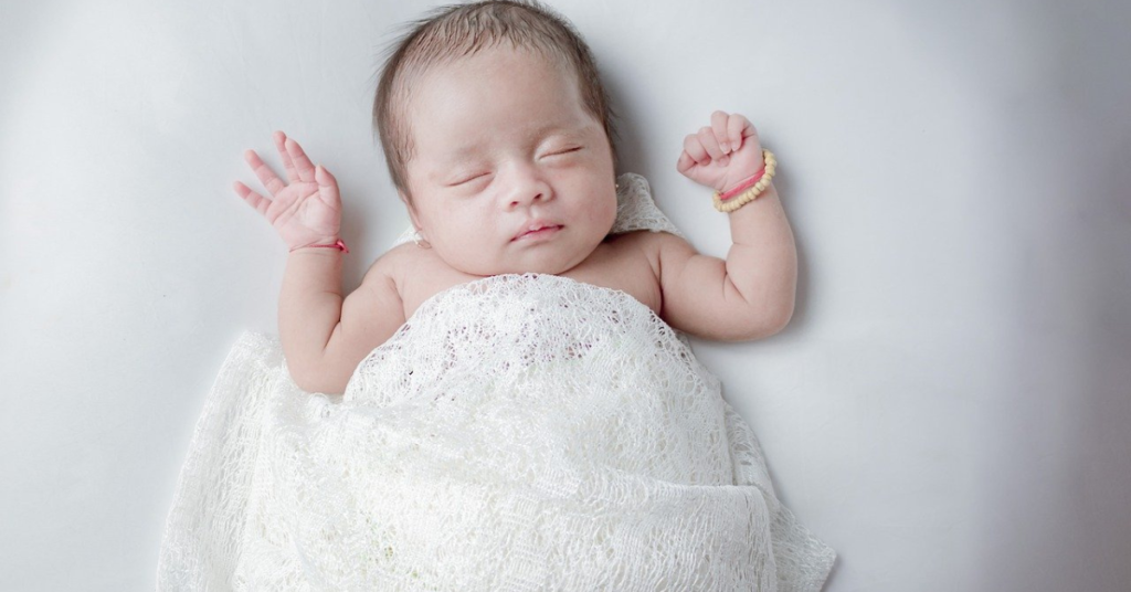 Peaceful child sleeping soundly in a cozy bed, highlighting the importance of restful sleep for healthy growth and development.