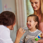 A pediatrician examining a smiling child during a routine health check-up, emphasizing the importance of pediatric care in India for healthy development.