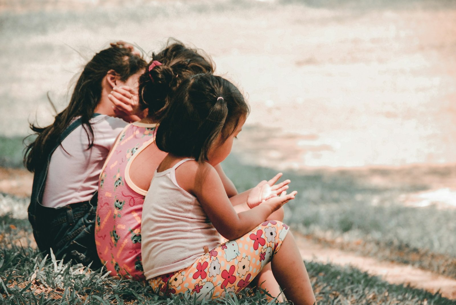 Three young children spending time together outdoors